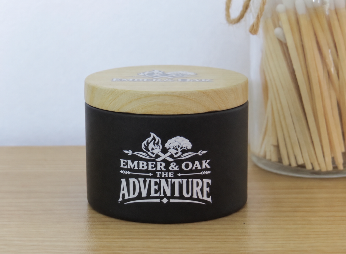 The Adventure 8oz luxury scented candle with wooden lid and Ember & Oak branding