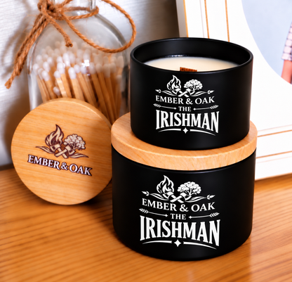     The Irishman luxury candle with wooden lid displayed alongside Ember & Oak packaging and accessories