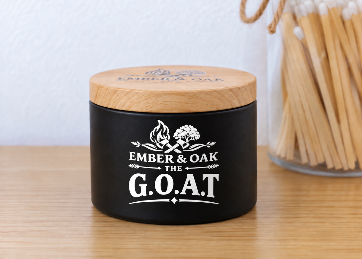    The G.O.A.T 8oz luxury scented candle with wooden lid and Ember & Oak branding