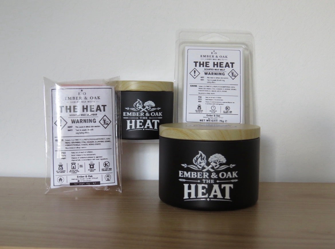    The Heat candle, wax melt and snap bar displayed together with Ember & Oak packaging