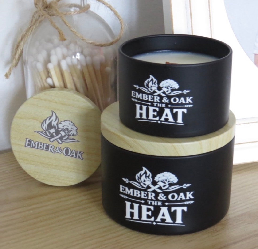     The Heat luxury candle with wooden lid displayed alongside Ember & Oak packaging and accessories