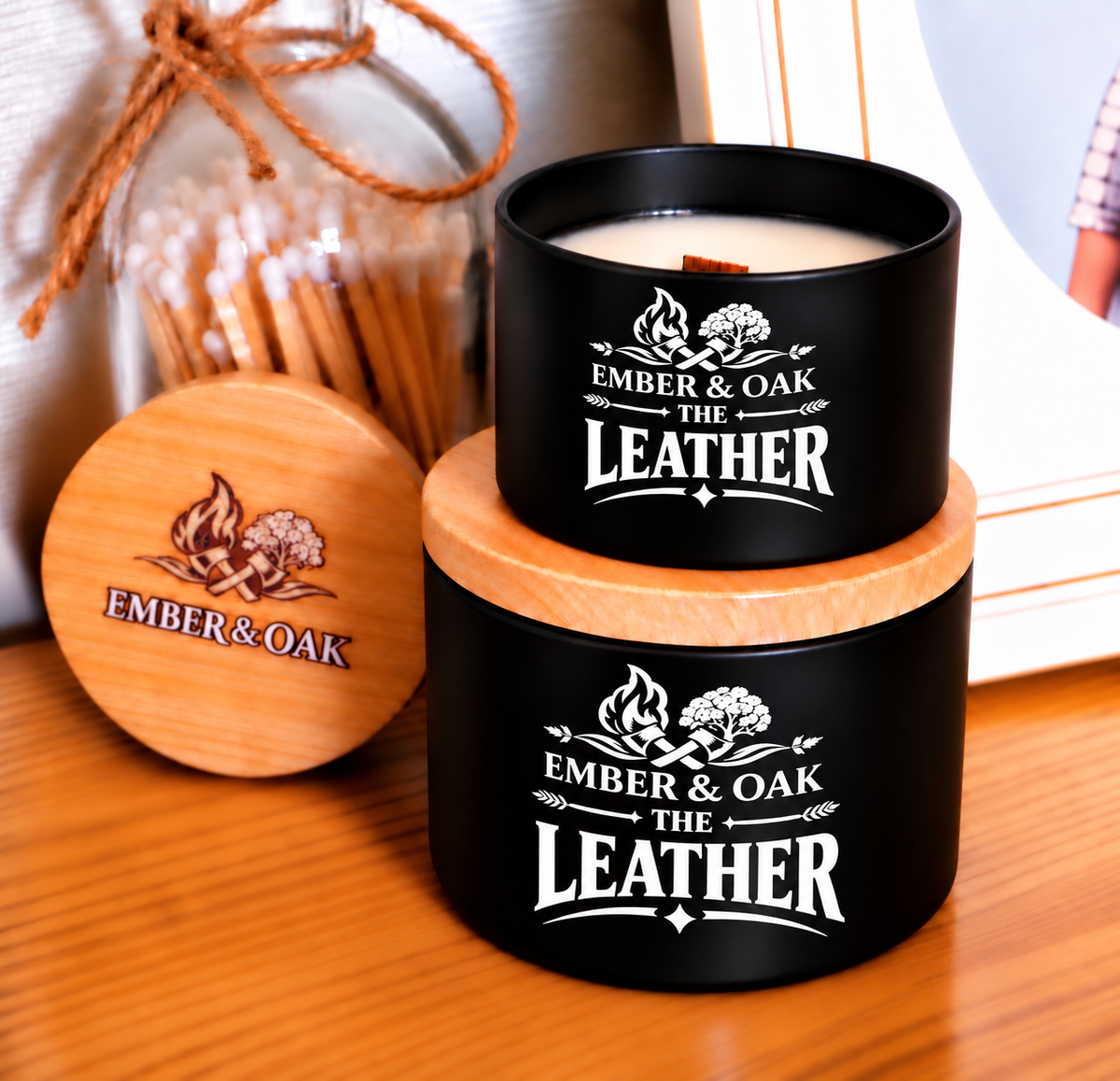 The Leather 8oz & 4oz candle with wooden lid displayed alongside Ember & Oak packaging