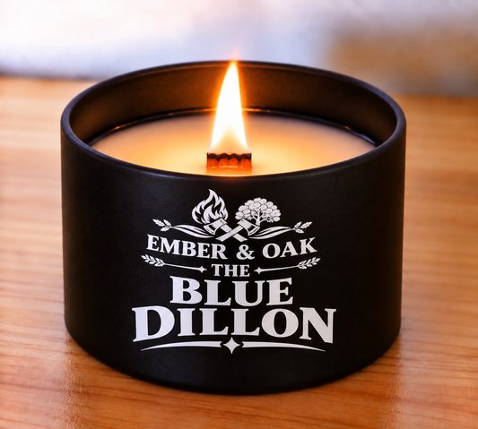     The Blue Dillon 8oz luxury scented candle burning with wooden wick and Ember & Oak branding