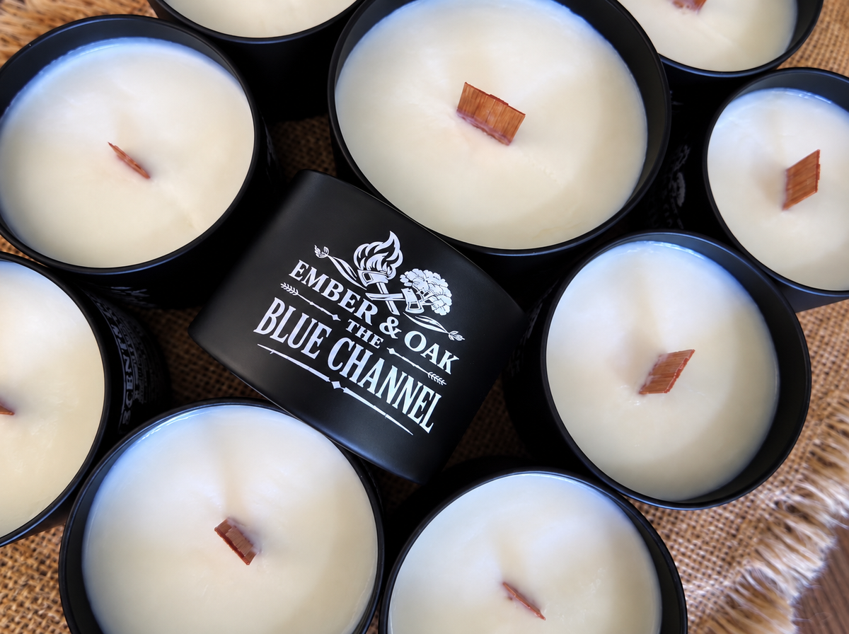     The Blue Channel luxury candle surrounded by multiple Ember & Oak candles