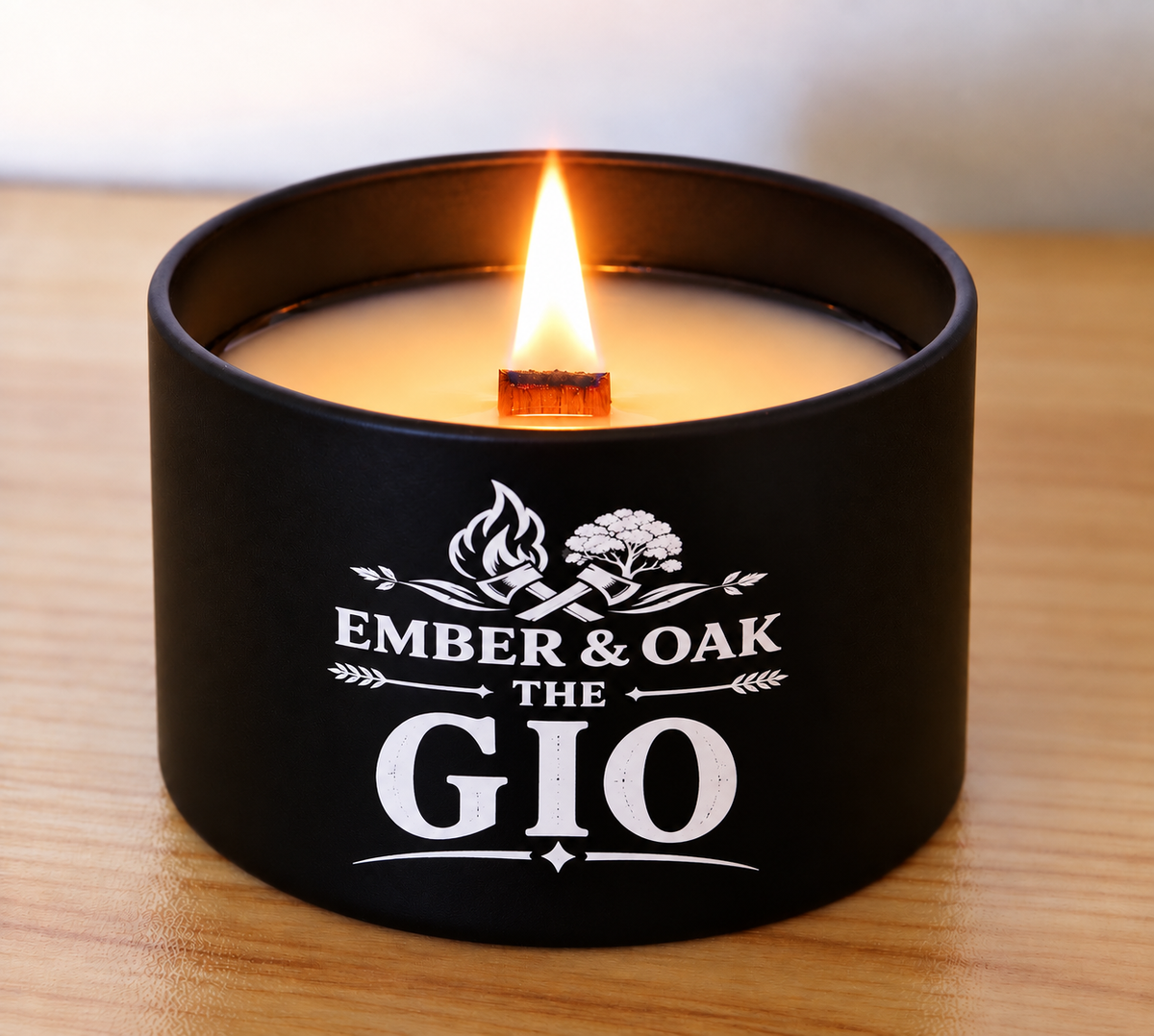 The Gio candle burning with its wooden wick and Ember & Oak label